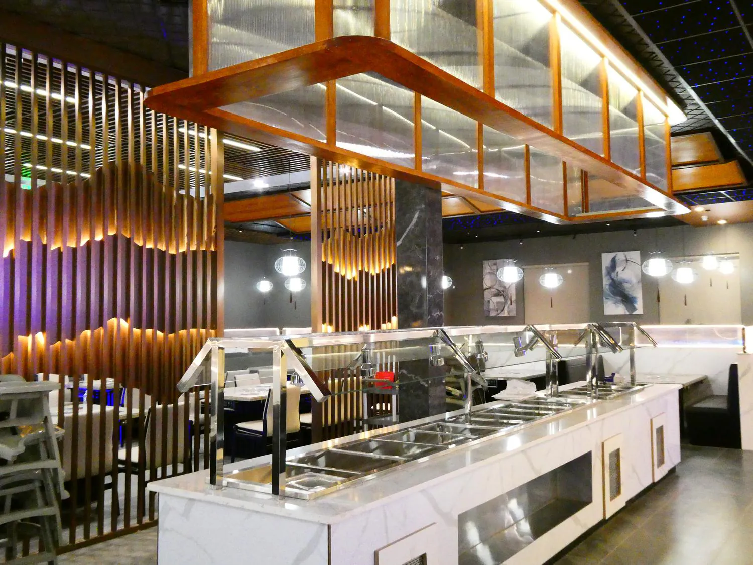 Legend-Pot-Hot-Pot-Restaurant-Baton-Rouge The interior of Legend Pot showcasing a modern buffet station with marble countertops and stylish wooden partition walls.